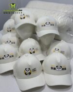 Nón đồng phục màu trắng in logo HAPPY PANDA cho tiệm trà sữa