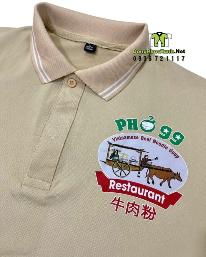 Áo nhân viên phục vụ màu be thiết kế viền trắng tay áo và cổ áo in logo nhà hàng Phở 99