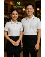 Bộ đồng phục quán cà phê có áo thun đồng phục màu trắng tạo cảm giác tươi mới và năng động, theo phong cách hiện đại, tối giản.