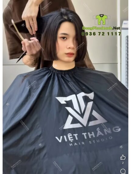 Áo choàng cắt tóc với hai màu màu đen và trắng dành cho Salon tóc, in logo Việt Thắng Hair Studio.