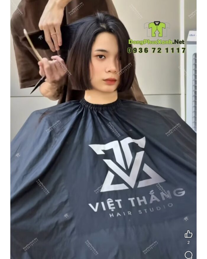 Áo choàng cắt tóc với hai màu màu đen và trắng dành cho Salon tóc, in logo Việt Thắng Hair Studio.