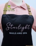 Tạp dề nail dành cho nhân viên màu đen chất liệu vải micro, in logo Starlight - Nails and Spa