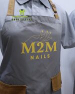 Tạp dề nail chống bám M2M kết hợp áo đồng phục nail vải poly cao cấp