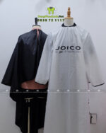 Áo choàng tóc in logo Joico vải dù màu đen dài tay chống bám dính